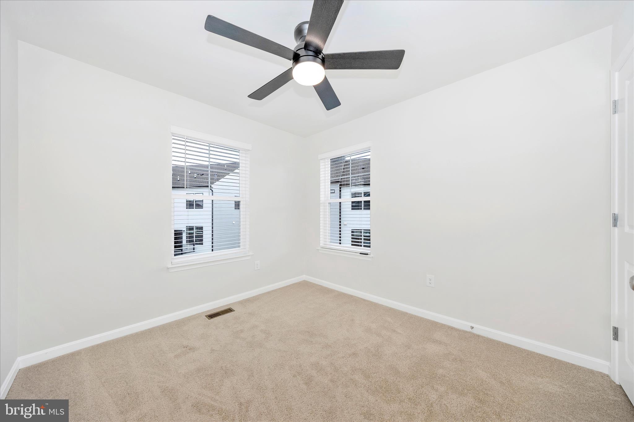 726 Compass Way Frederick, MD 21701 - Photo 43 of 55 an empty room with windows and fan