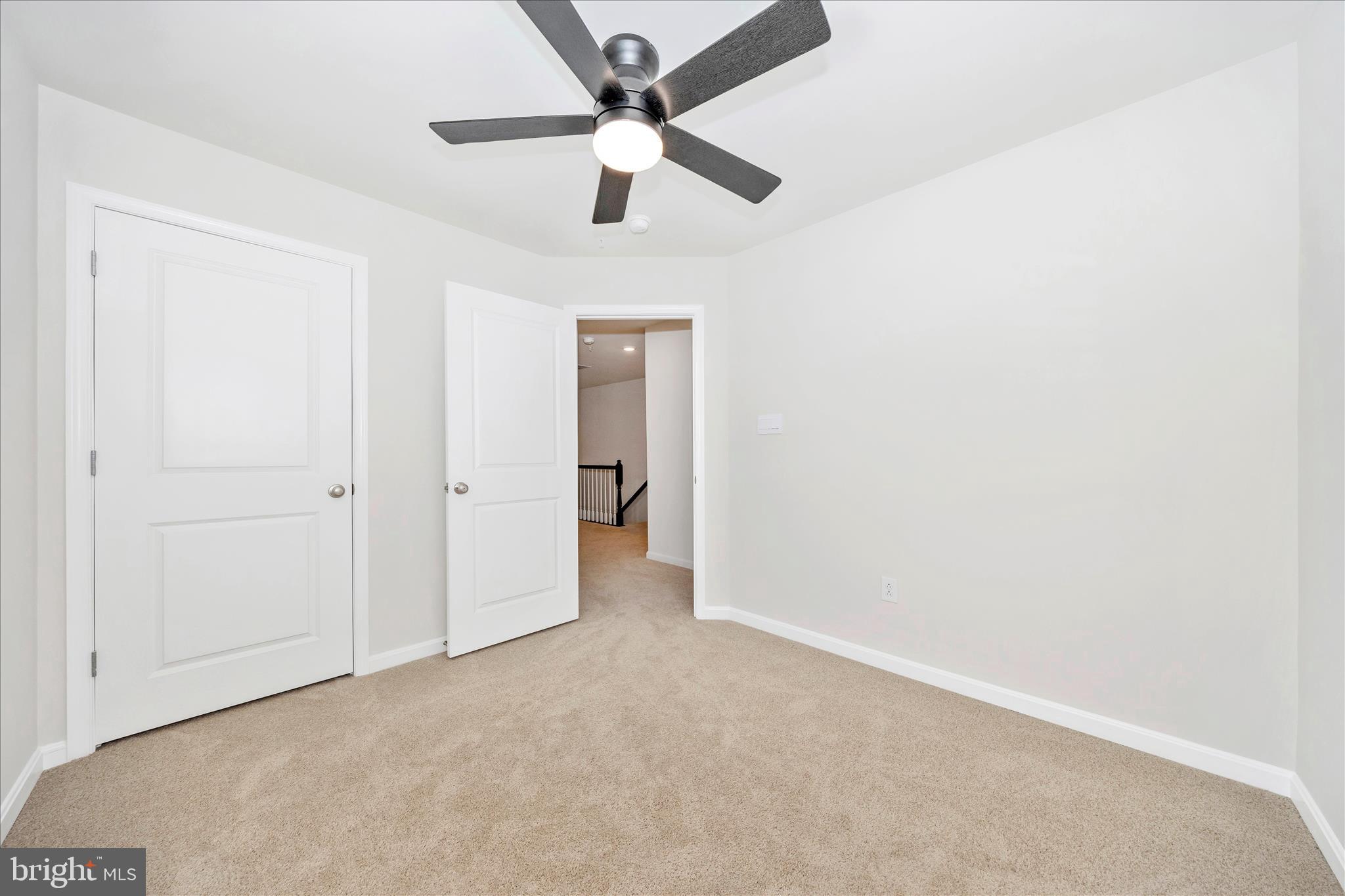 726 Compass Way Frederick, MD 21701 - Photo 45 of 55 an empty room with a ceiling fan and a window