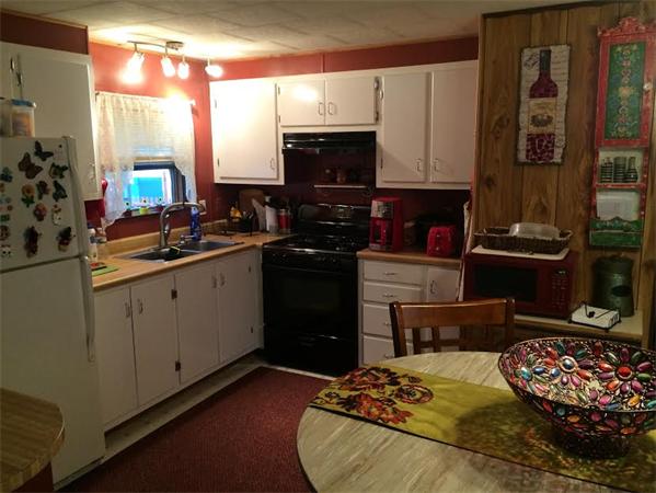 72 Kendall Pond Road, Unit 11 Derry, NH 03038 - Photo 2 of 8 a kitchen with a sink stove and microwave