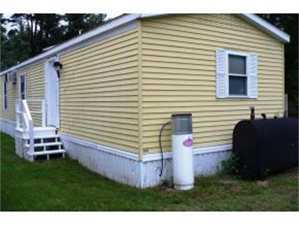 72 Kendall Pond Road, Unit 11 Derry, NH 03038 - Photo 5 of 8 a backyard of a house with wooden deck and furniture