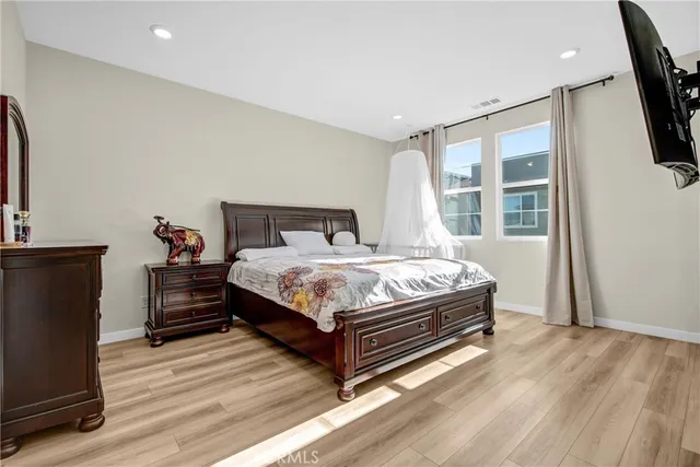 a bed sitting in a bedroom next to a window
