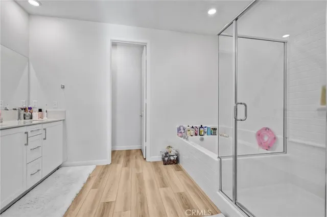a hallway with cabinets and wooden floor
