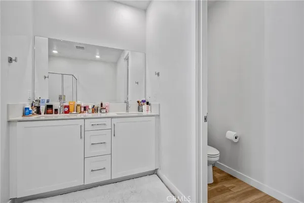 a bathroom with a sink mirror and a toilet