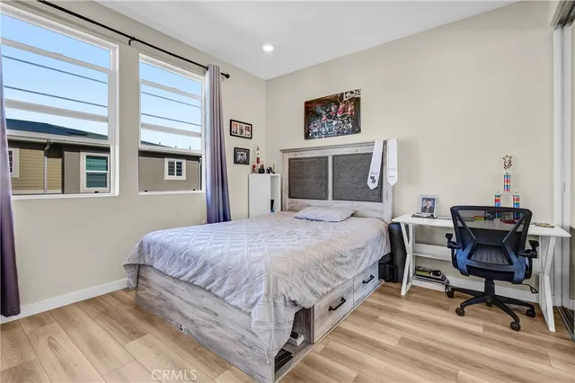 a bedroom with a bed and a desk