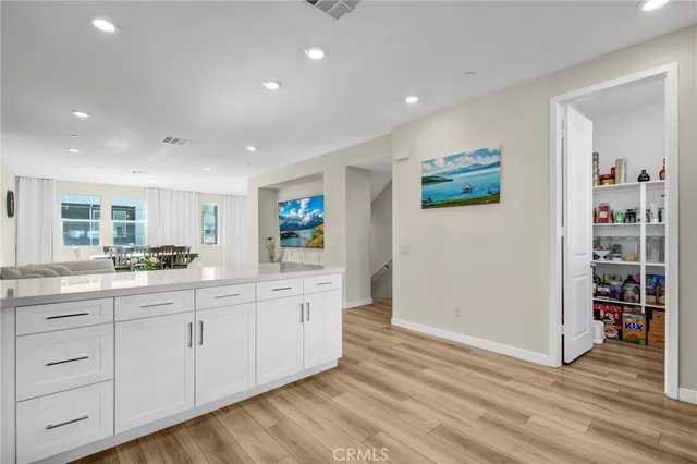 a large white kitchen with double vanity sink and a window