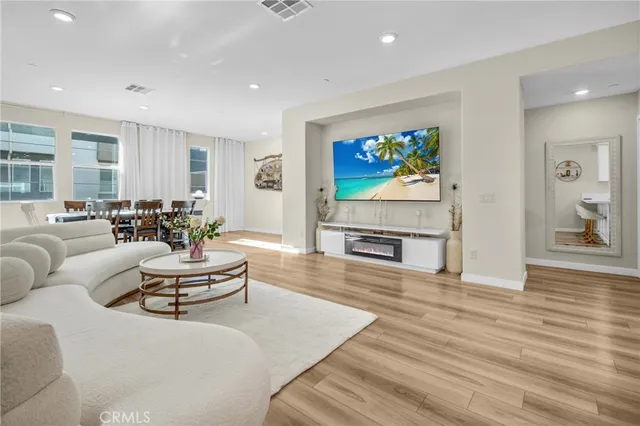 a living room with fireplace furniture and a wooden floor