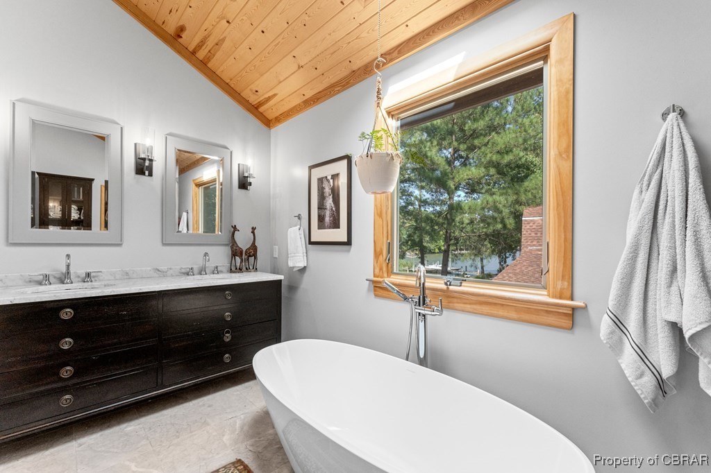1106 Monarch Shores Road Kilmarnock, VA 22482 - Photo 26 of 44 Bathroom featuring vanity, a wealth of natural light, a washtub, wooden ceiling, and vaulted ceiling