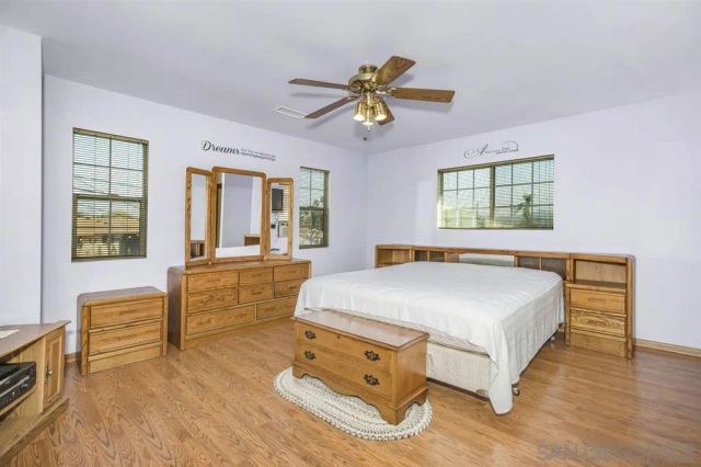 a spacious bedroom with a bed and a chandelier