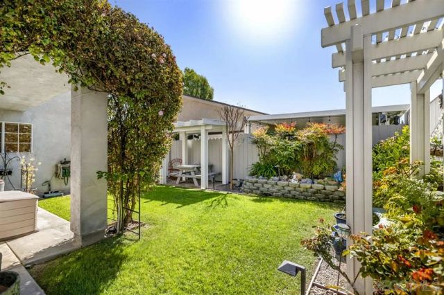 a view of house with backyard outdoor seating and hardwood floor