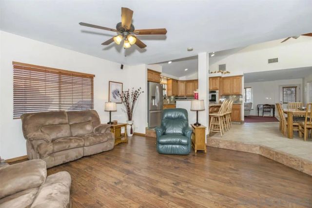 a living room with furniture and kitchen view
