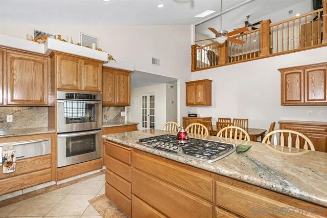 a kitchen with stainless steel appliances granite countertop a stove and a sink