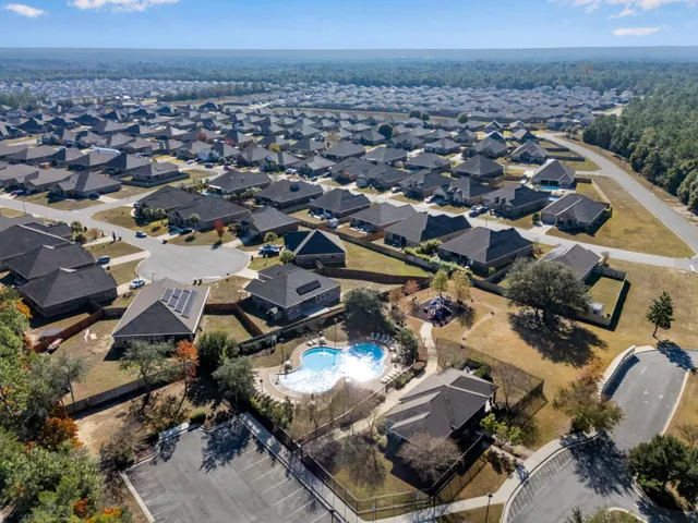 an aerial view of a residential houses with outdoor space