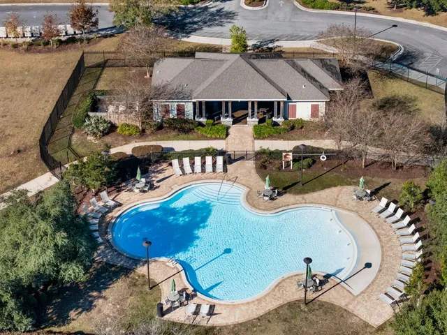 an aerial view of a house with a yard