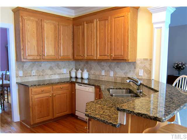 2000 Wheelerbrook Court Raleigh, NC 27603 - Photo 5 of 12 42" Oak Cabinets, Granite Counters, Custom Tile Backsplash - Great space to cook and gather! Kitchen