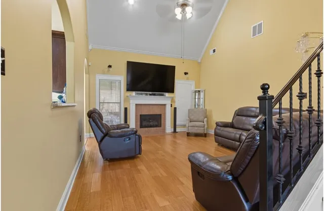 a living room with furniture flat screen tv and a fireplace