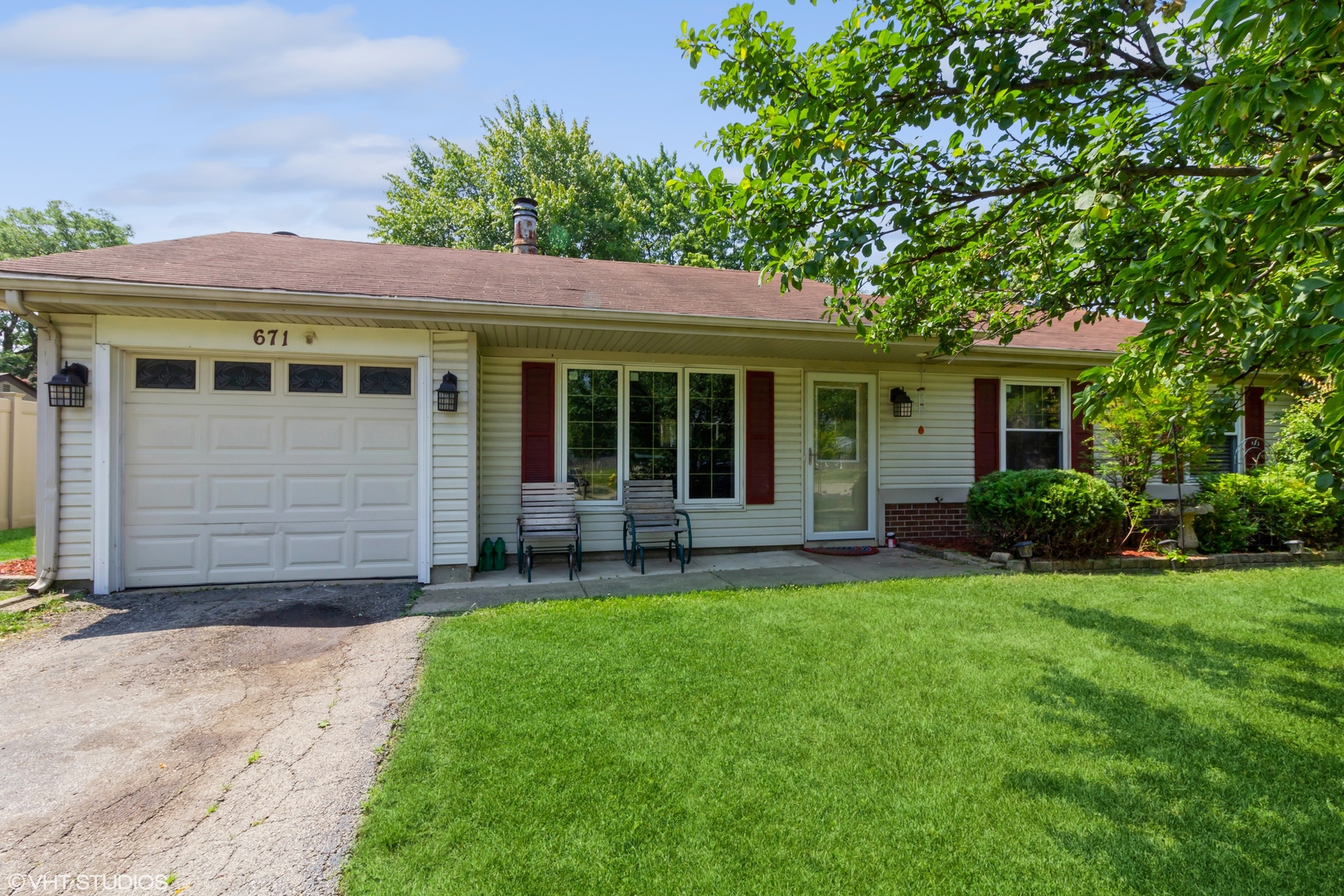 671 Rockhurst Road Bolingbrook, IL 60440 - Photo 1 of 17 a front view of a house with a yard and porch