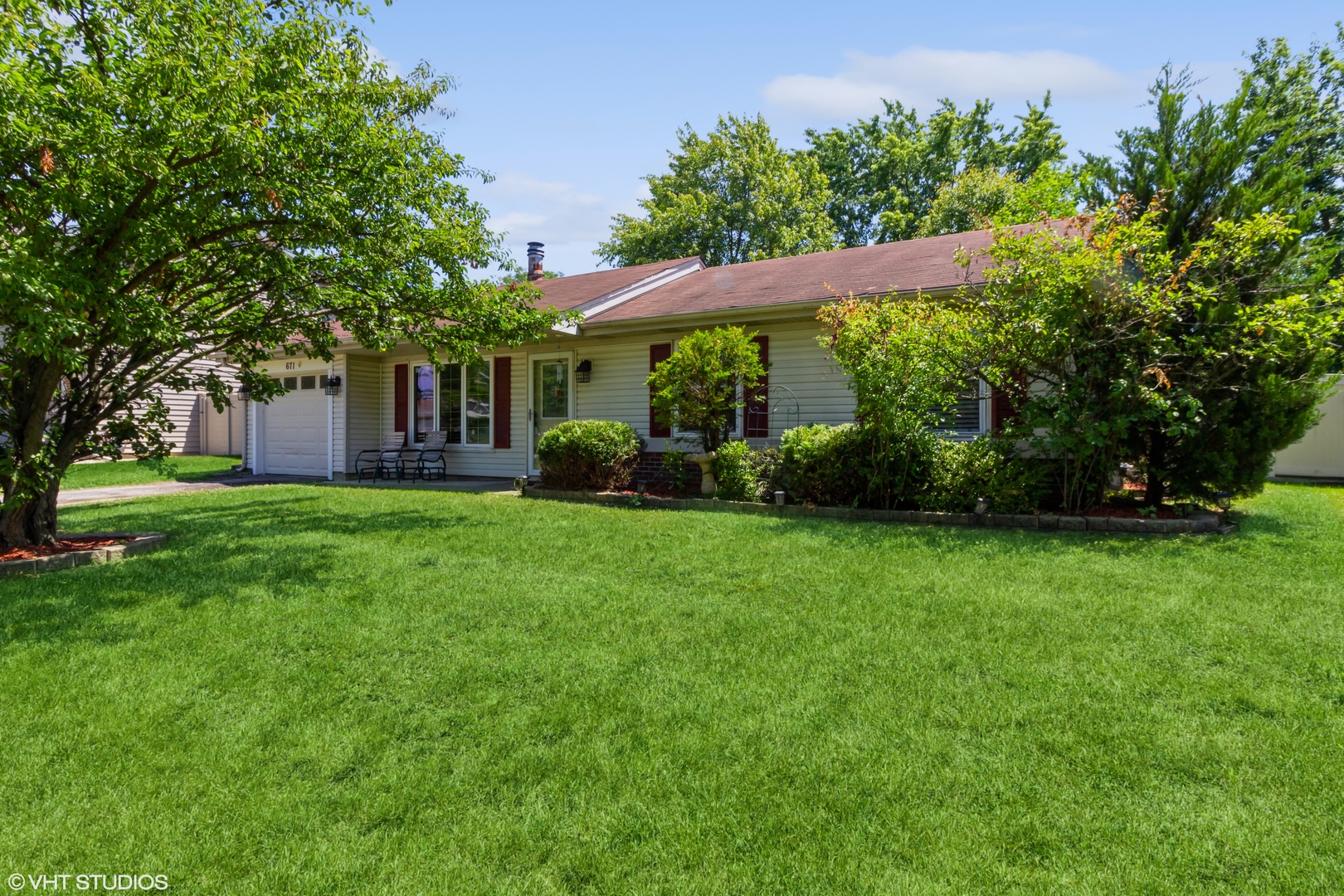 671 Rockhurst Road Bolingbrook, IL 60440 - Photo 2 of 17 a view of a house next to a big yard and large trees