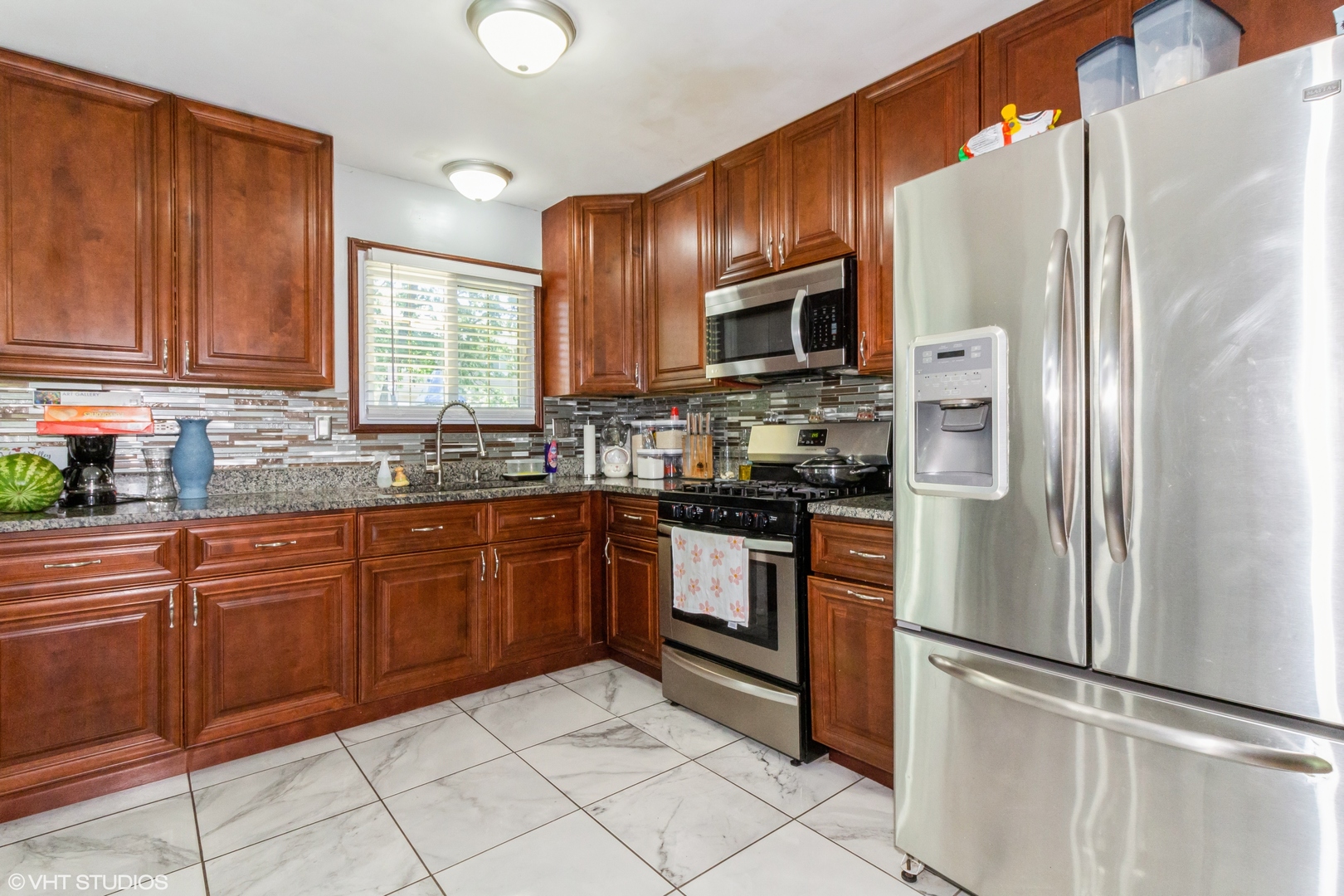 671 Rockhurst Road Bolingbrook, IL 60440 - Photo 6 of 17 a kitchen with granite countertop stainless steel appliances a refrigerator sink and microwave