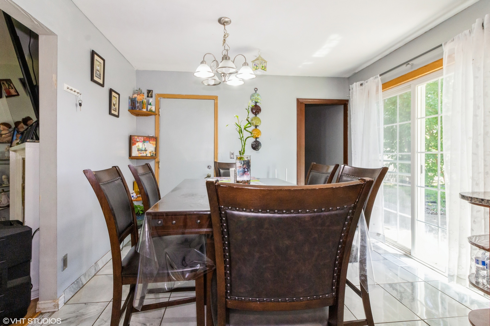671 Rockhurst Road Bolingbrook, IL 60440 - Photo 7 of 17 a dining room with furniture a chandelier and window