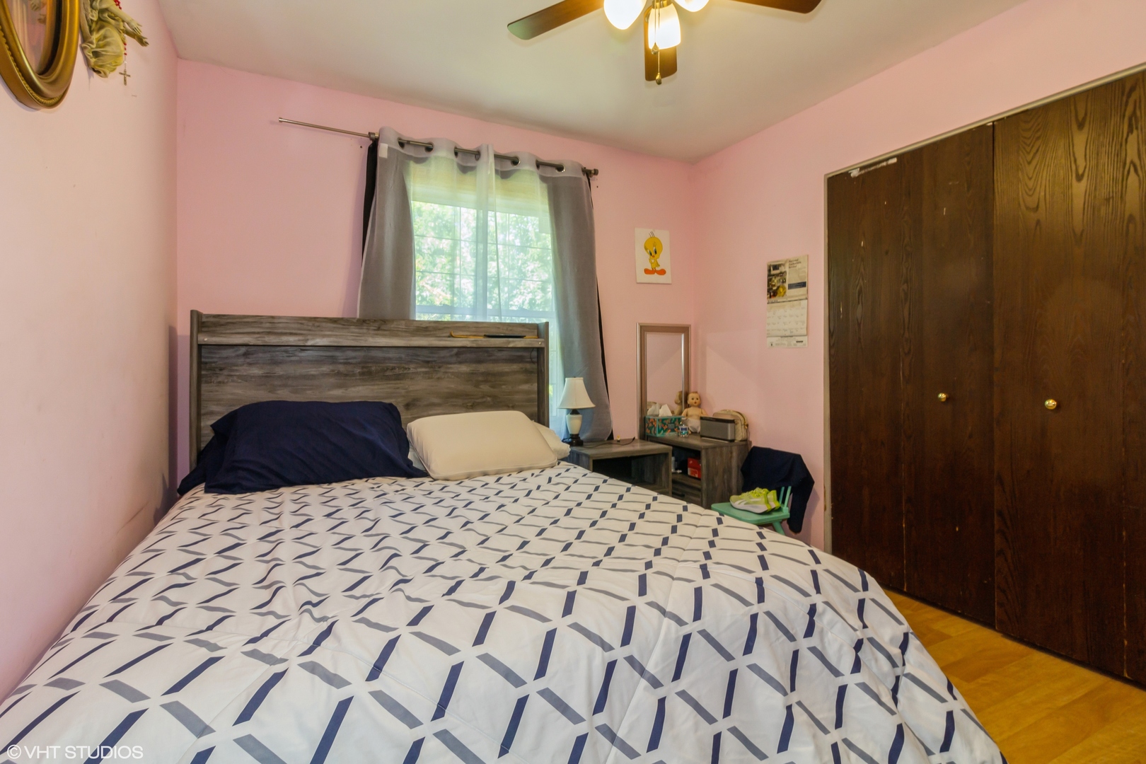 671 Rockhurst Road Bolingbrook, IL 60440 - Photo 10 of 17 a bedroom with a large bed and a chandelier