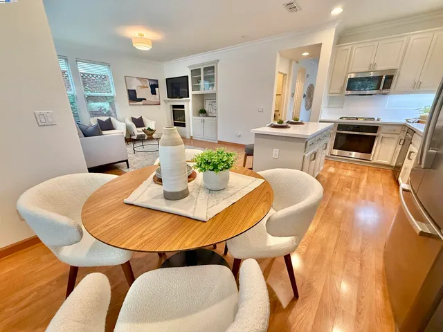 a dining room with furniture a table and kitchen view
