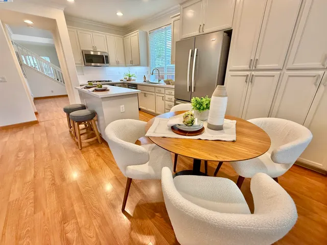a dining room with furniture and wooden floor