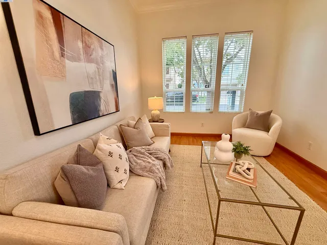 a living room with furniture and a floor to ceiling window