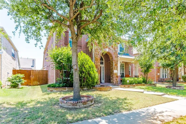 a front view of a house with a yard and fountain