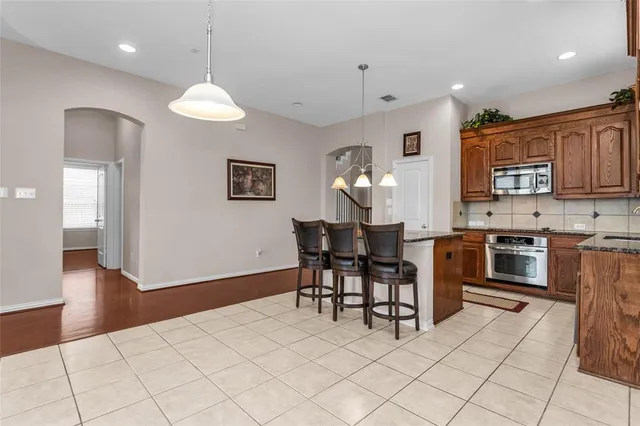 a kitchen with stainless steel appliances granite countertop a stove and cabinets