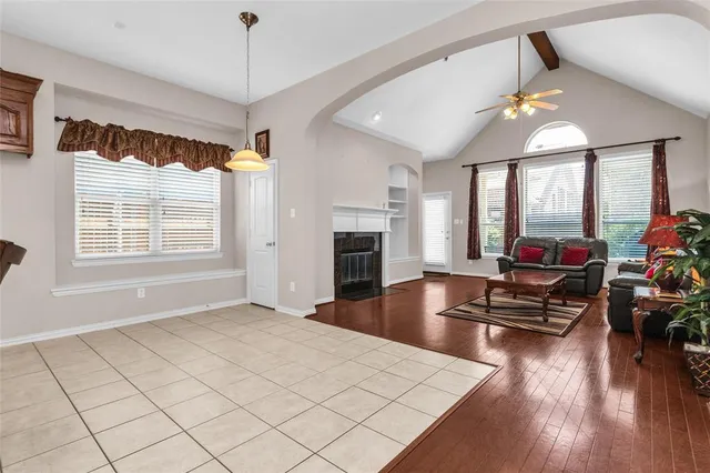 a kitchen with kitchen island granite countertop wooden floors and white cabinets