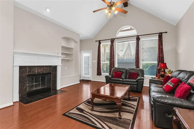 a living room with furniture fireplace and wooden floor