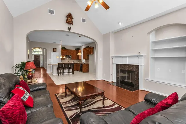 a living room with furniture and a wooden floor