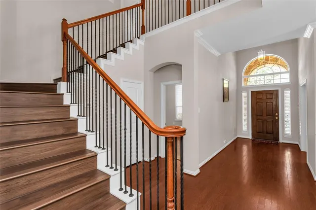 a view of a room with wooden floor and a window