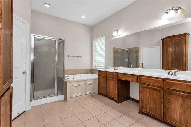 a view of an empty room with wooden floor and a ceiling fan
