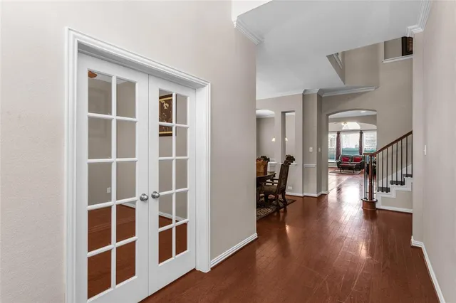 a hallway with wooden floor and windows