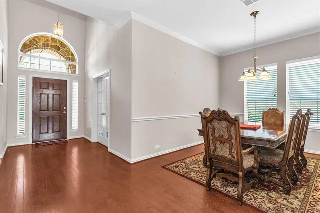 a view of a dining room with furniture and a chandelier