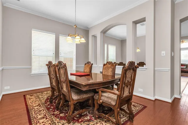 a view of a a dining room with furniture window and wooden floor