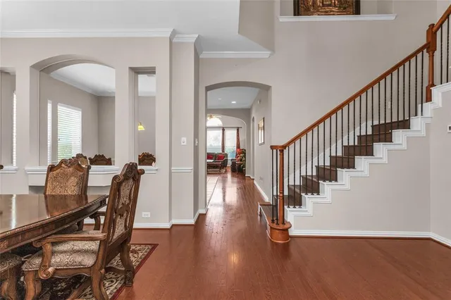 a hallway with wooden floor and furniture