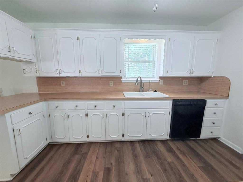 160 Bob White Road Denison, TX 75020 - Photo 7 of 29 Kitchen featuring white cabinetry, light wood-finish countertops, and wood-finish flooring