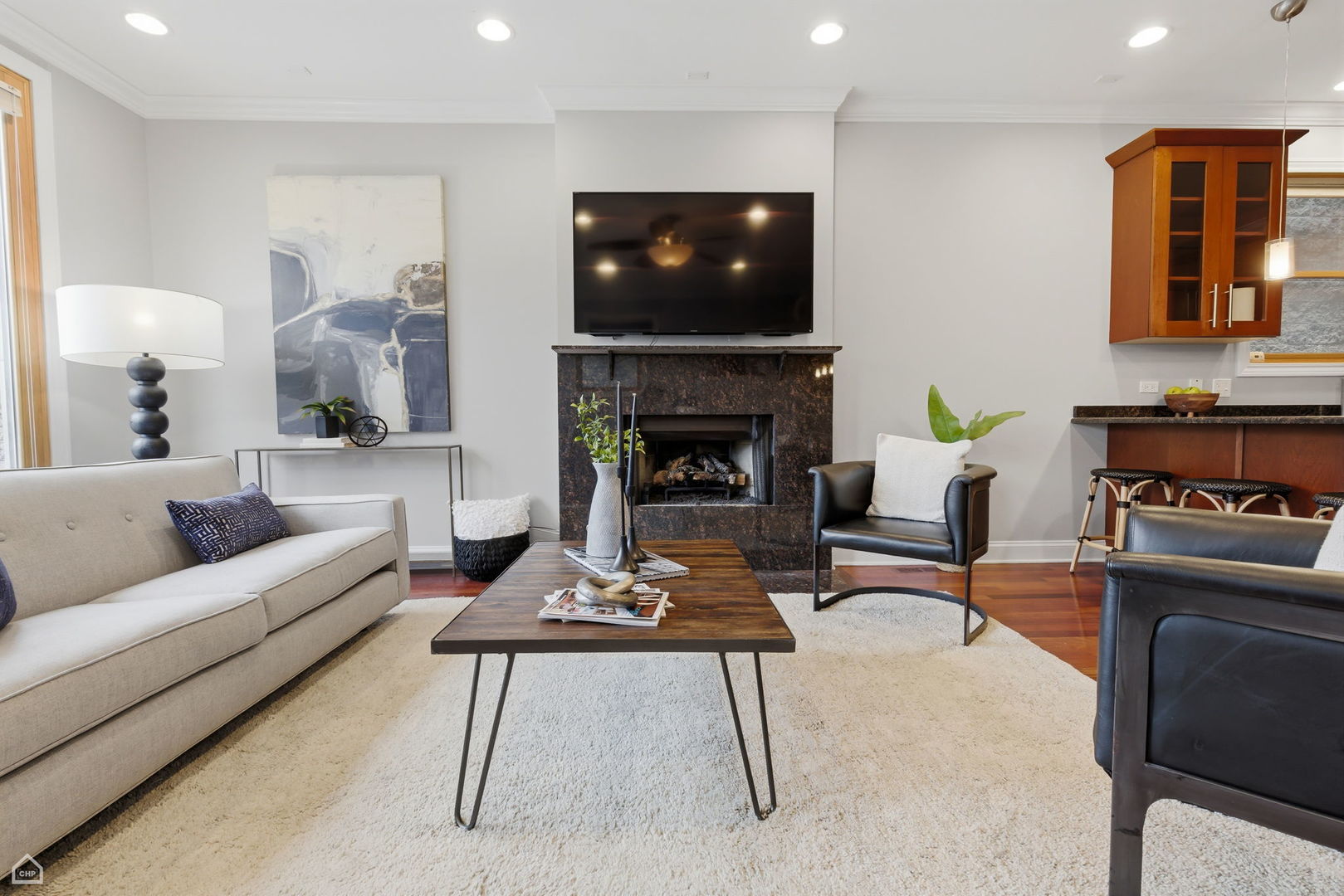 2229 North Leavitt Street, Unit 2 Chicago, IL 60647 - Photo 2 of 19 a living room with furniture a fireplace and a flat screen tv