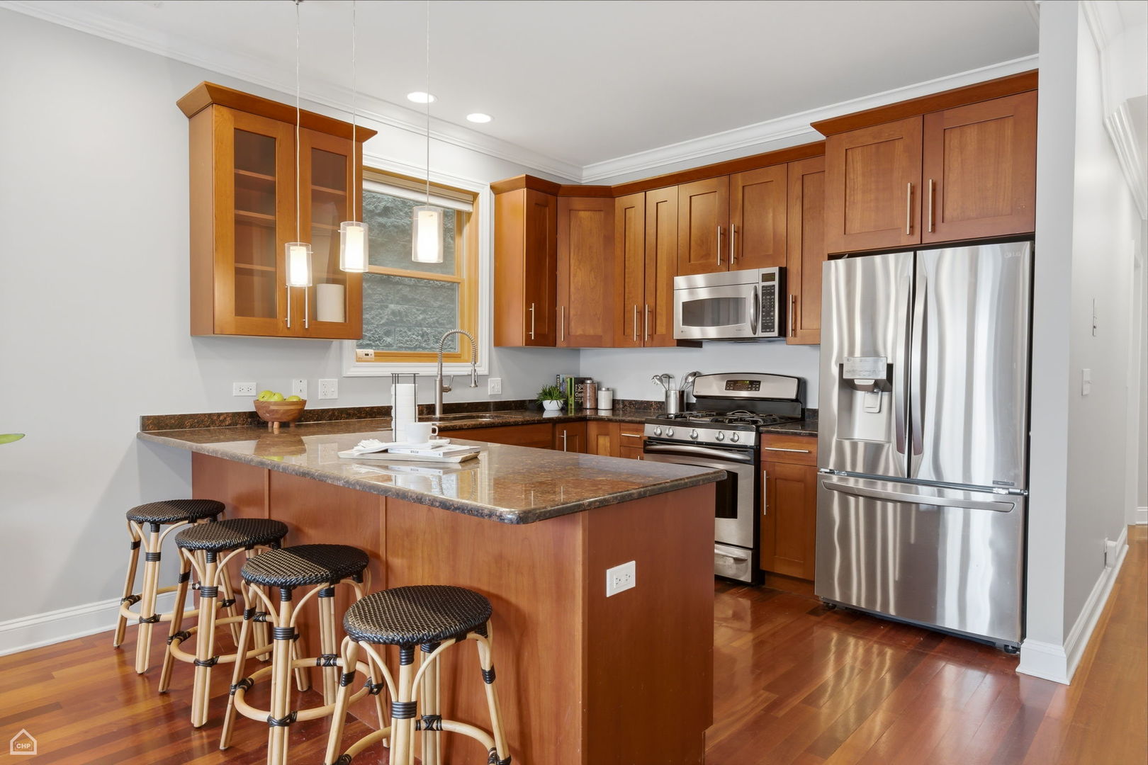 2229 North Leavitt Street, Unit 2 Chicago, IL 60647 - Photo 5 of 19 a kitchen with stainless steel appliances granite countertop a refrigerator stove microwave and sink