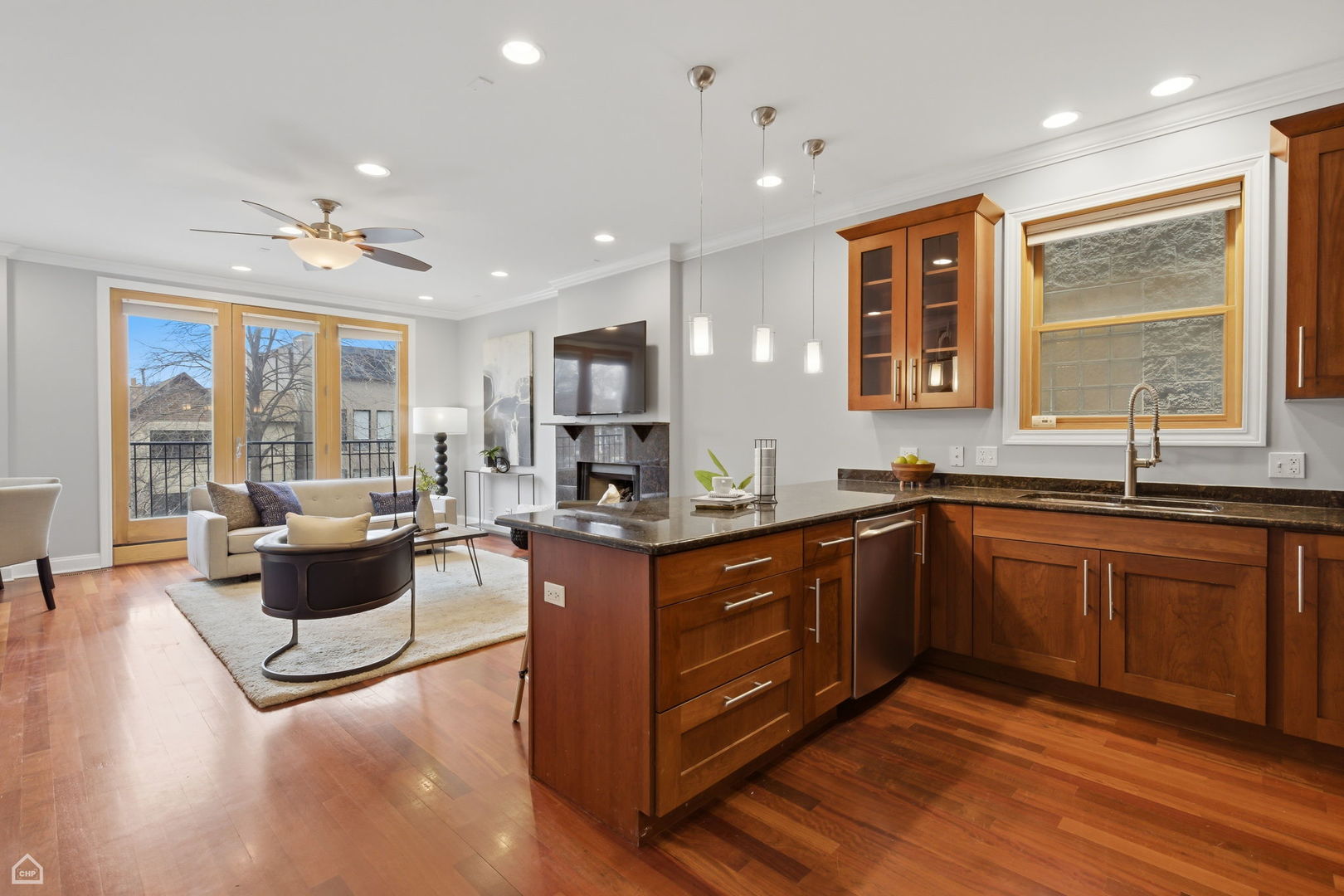 2229 North Leavitt Street, Unit 2 Chicago, IL 60647 - Photo 7 of 19 a large kitchen with stainless steel appliances granite countertop a large center island and a sink