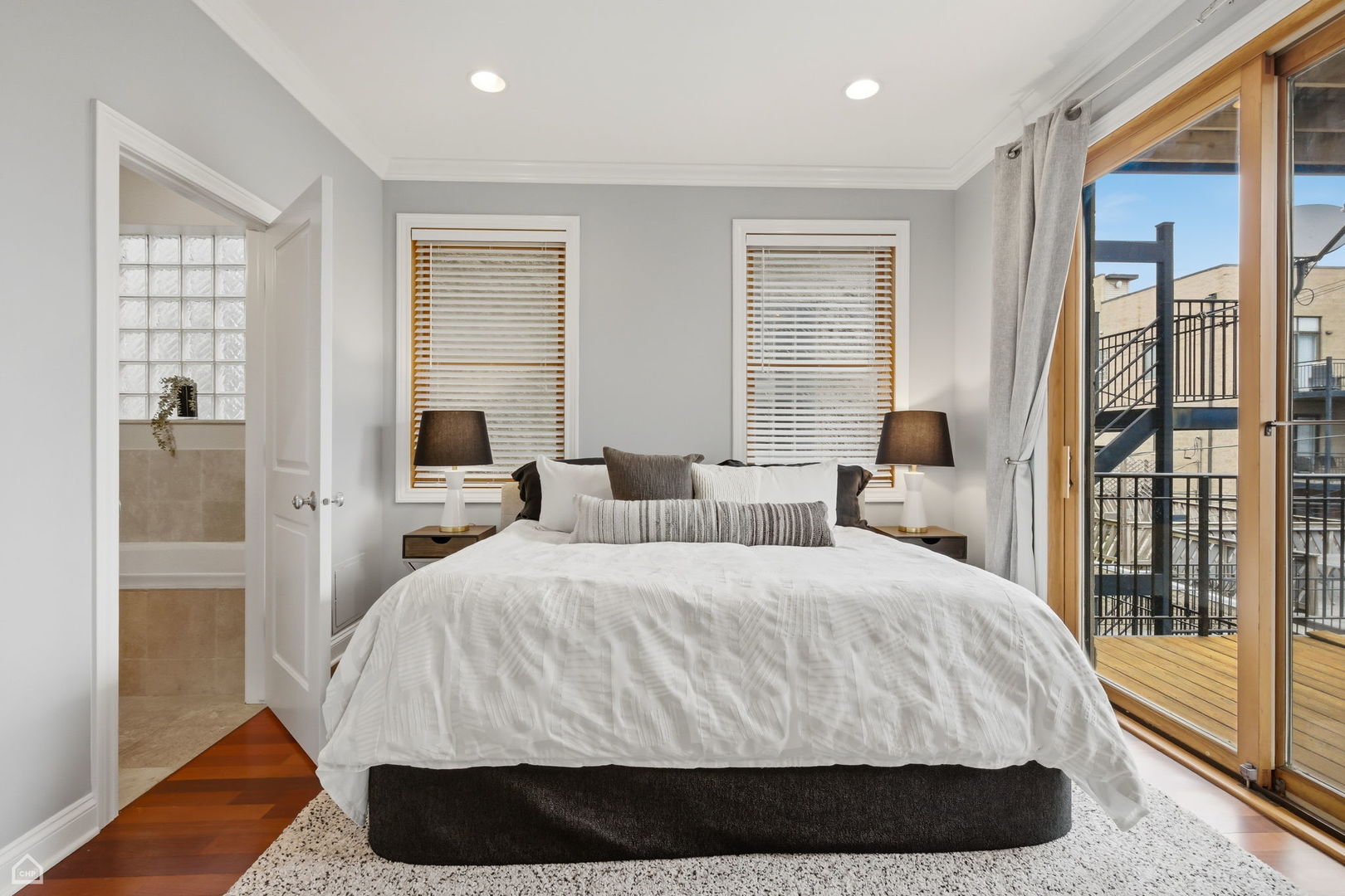 2229 North Leavitt Street, Unit 2 Chicago, IL 60647 - Photo 9 of 19 a bedroom with a bed and wooden floor