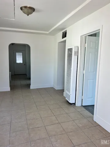 a view of a livingroom with an empty space and a window