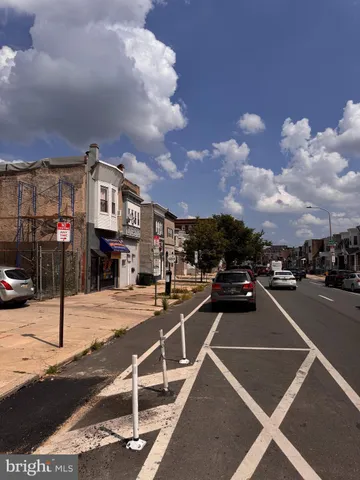 a view of a city street with car parked