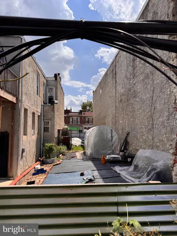a backyard of a house with barbeque oven and outdoor seating