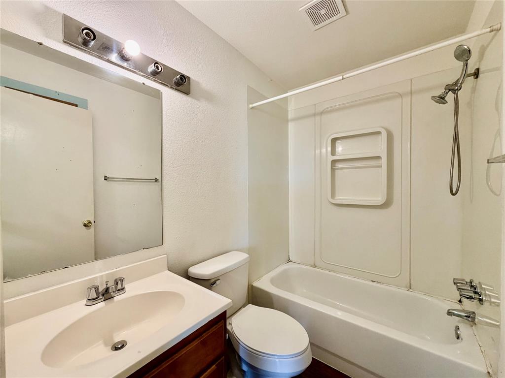 3311 Fallmeadow Street Denton, TX 76207 - Photo 11 of 13 a bathroom with a sink mirror toilet and bathtub