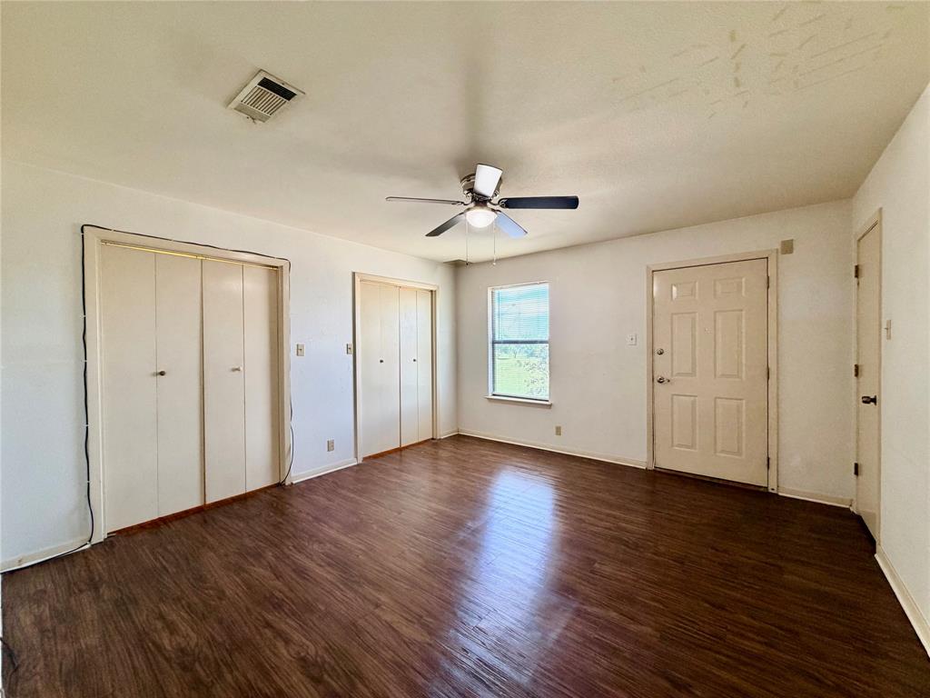 3311 Fallmeadow Street Denton, TX 76207 - Photo 12 of 13 a view of an empty room with wooden floor and a ceiling fan