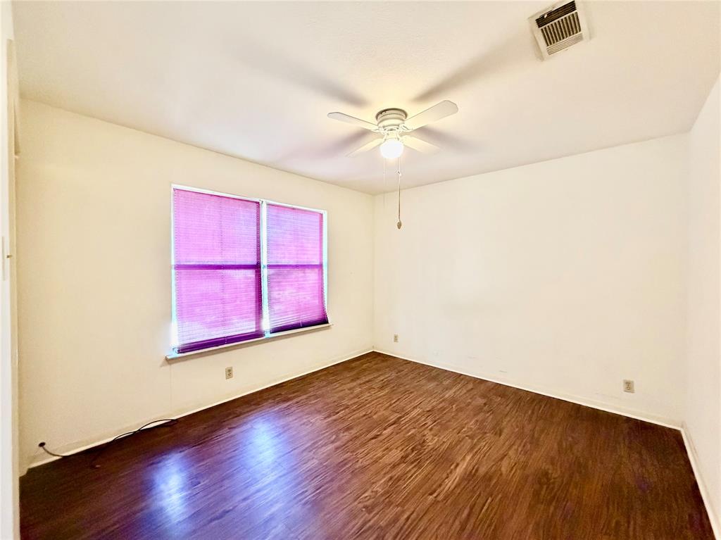 3311 Fallmeadow Street Denton, TX 76207 - Photo 13 of 13 an empty room with wooden floor and windows