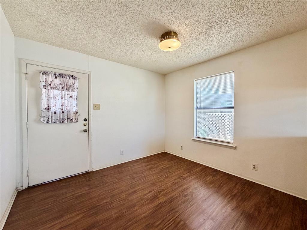 3311 Fallmeadow Street Denton, TX 76207 - Photo 6 of 13 an empty room with wooden floor and window